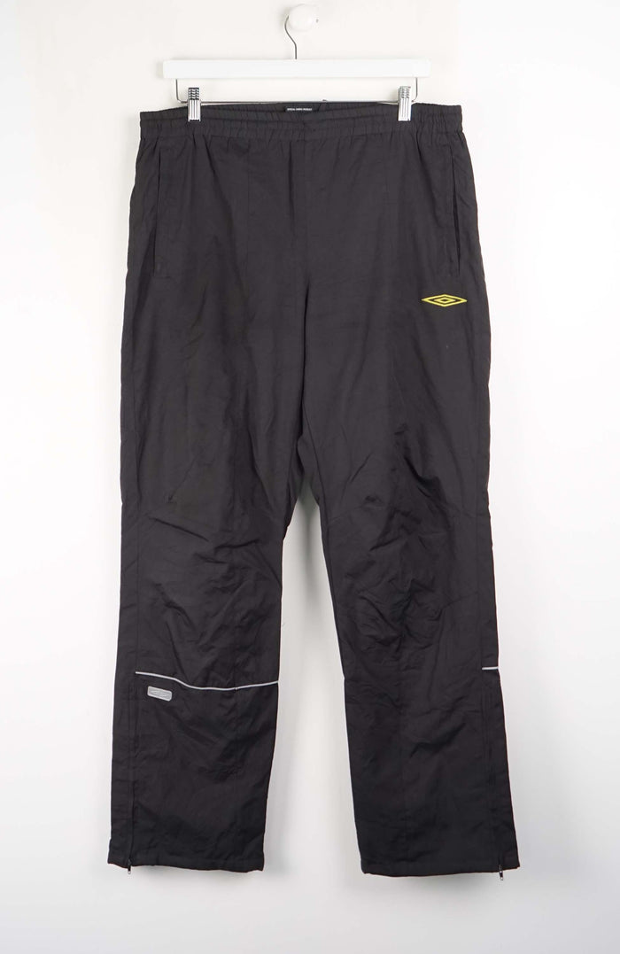 Black pants with a yellow logo on a white background