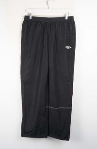 Black athletic pants with a logo on a white background