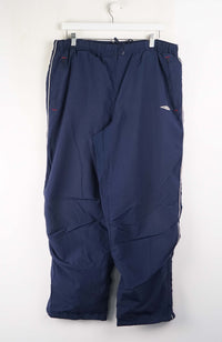 Navy blue pants on a white hanger against a white background