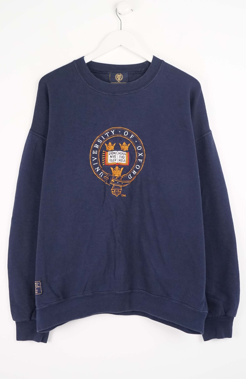 Navy blue sweatshirt with a crest design on a white background