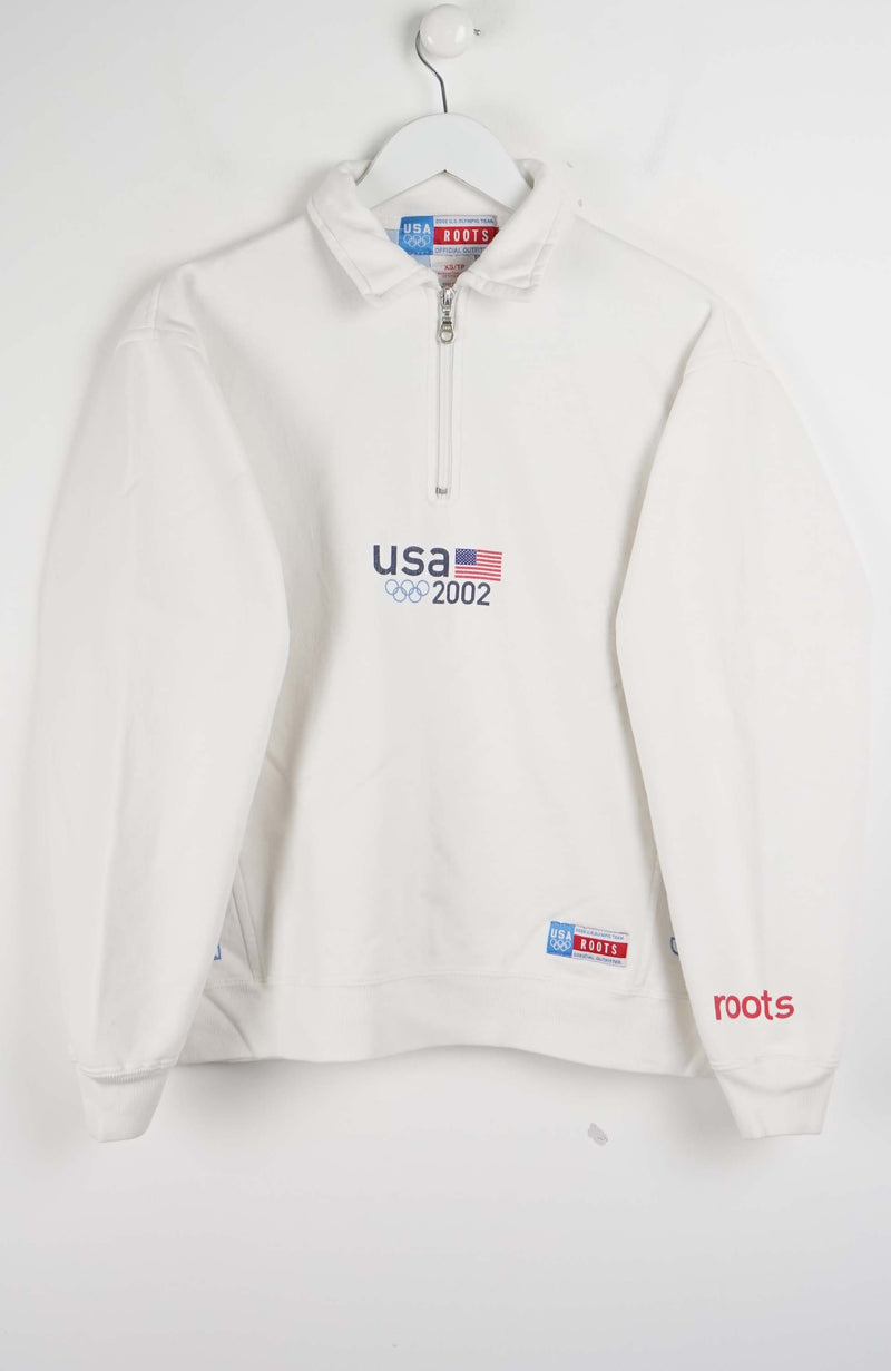 White pullover with 'USA 2002' and 'roots' branding on a white background