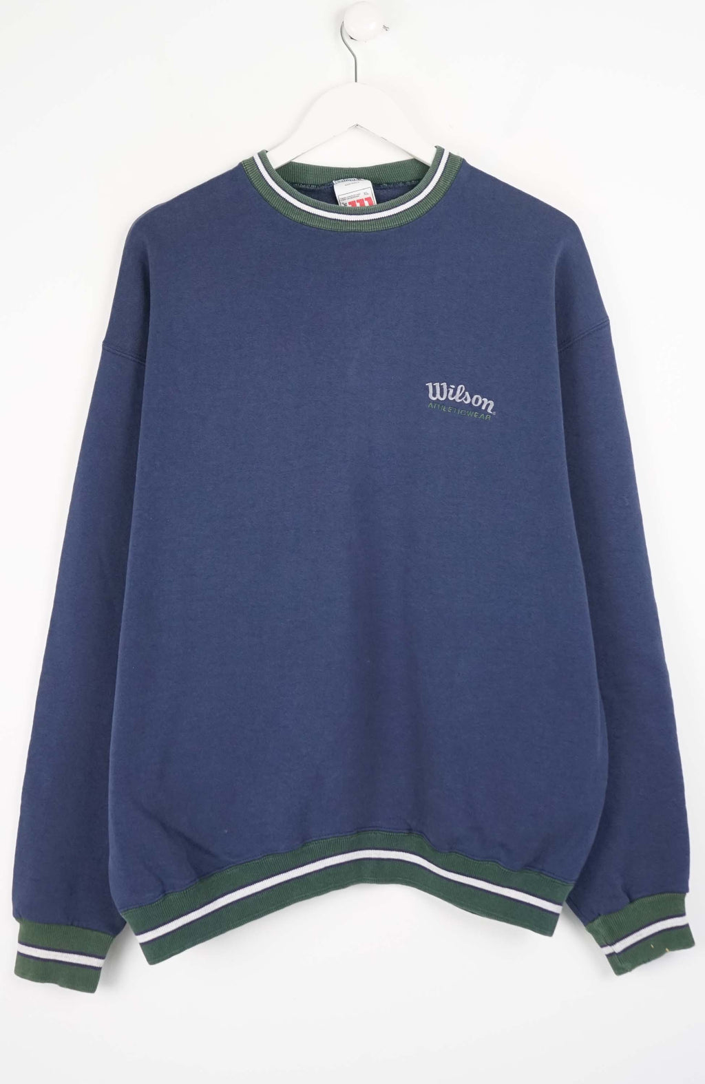 Blue sweatshirt with green and white trim on a hanger against a white background