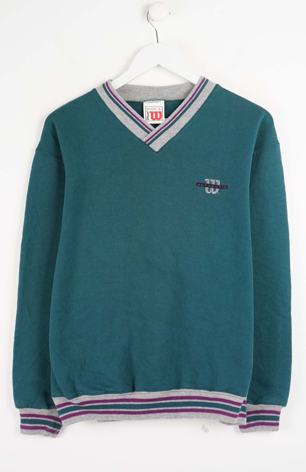 Teal sweater with striped trim on a white background