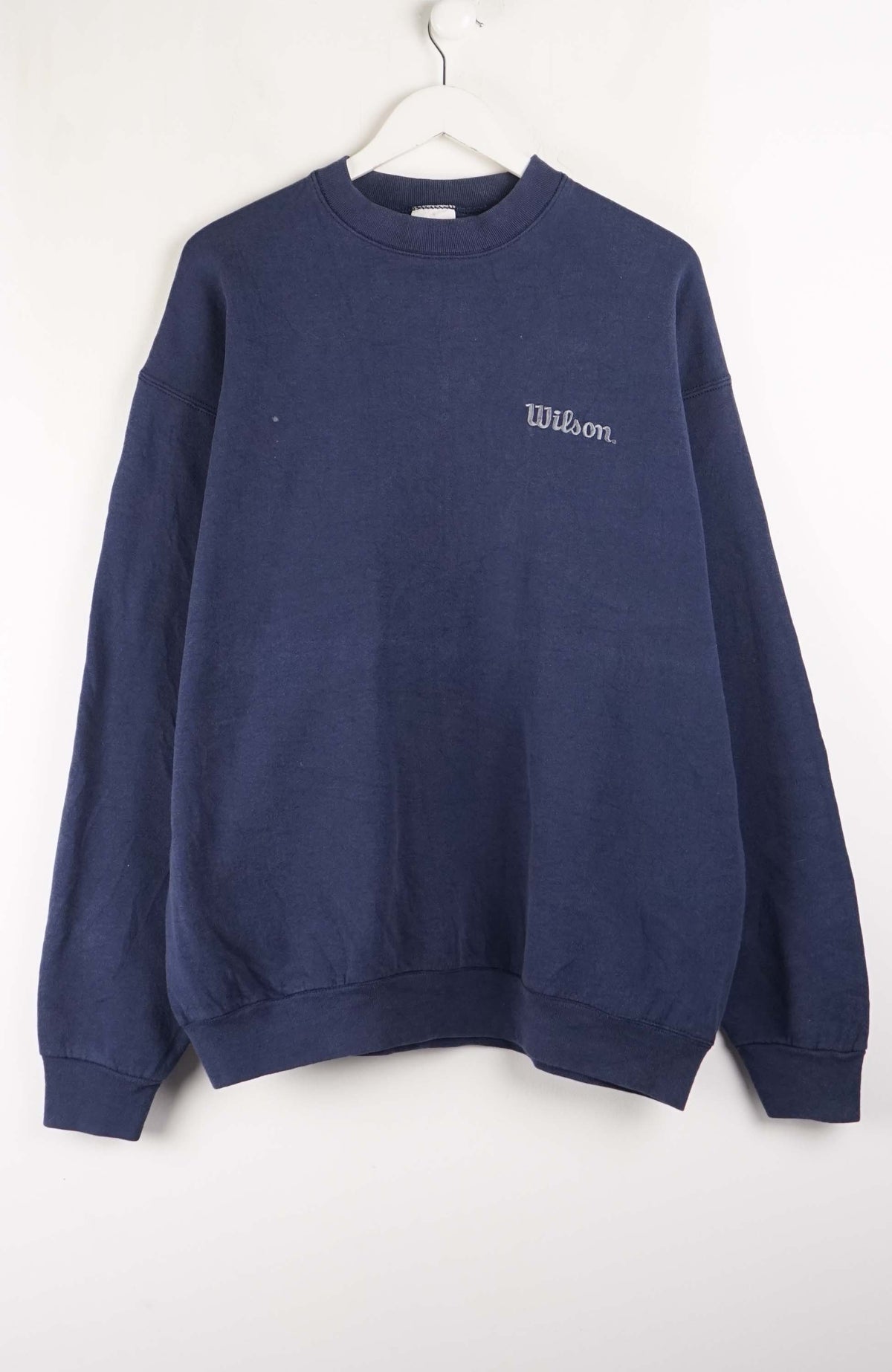 Navy blue sweatshirt with 'Wilson' logo on a white background
