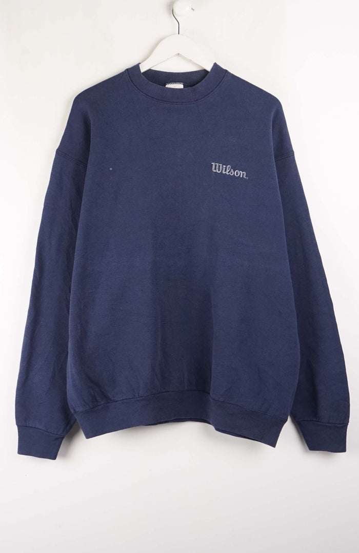 Navy blue sweatshirt with 'Wilson' logo on a white background